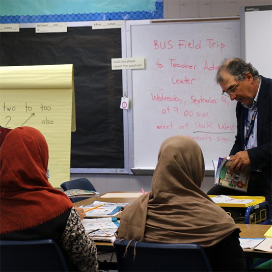  A staff member works with parents on learning english